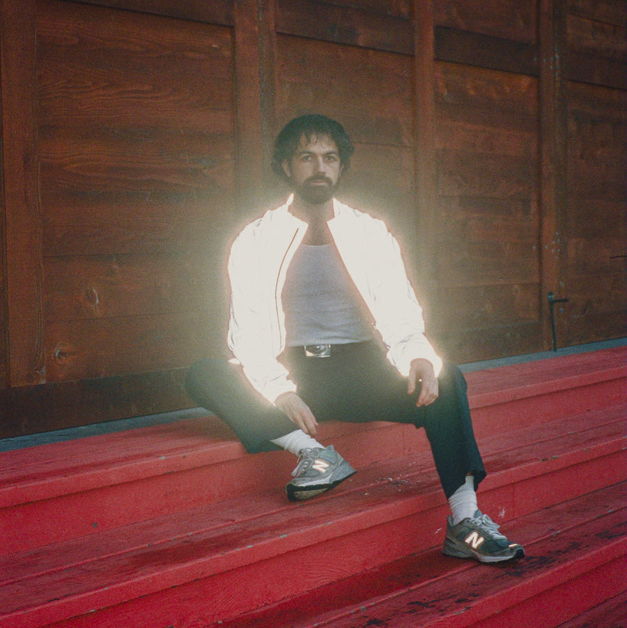 Pastel Blank sitting on red steps with a wooden wall background